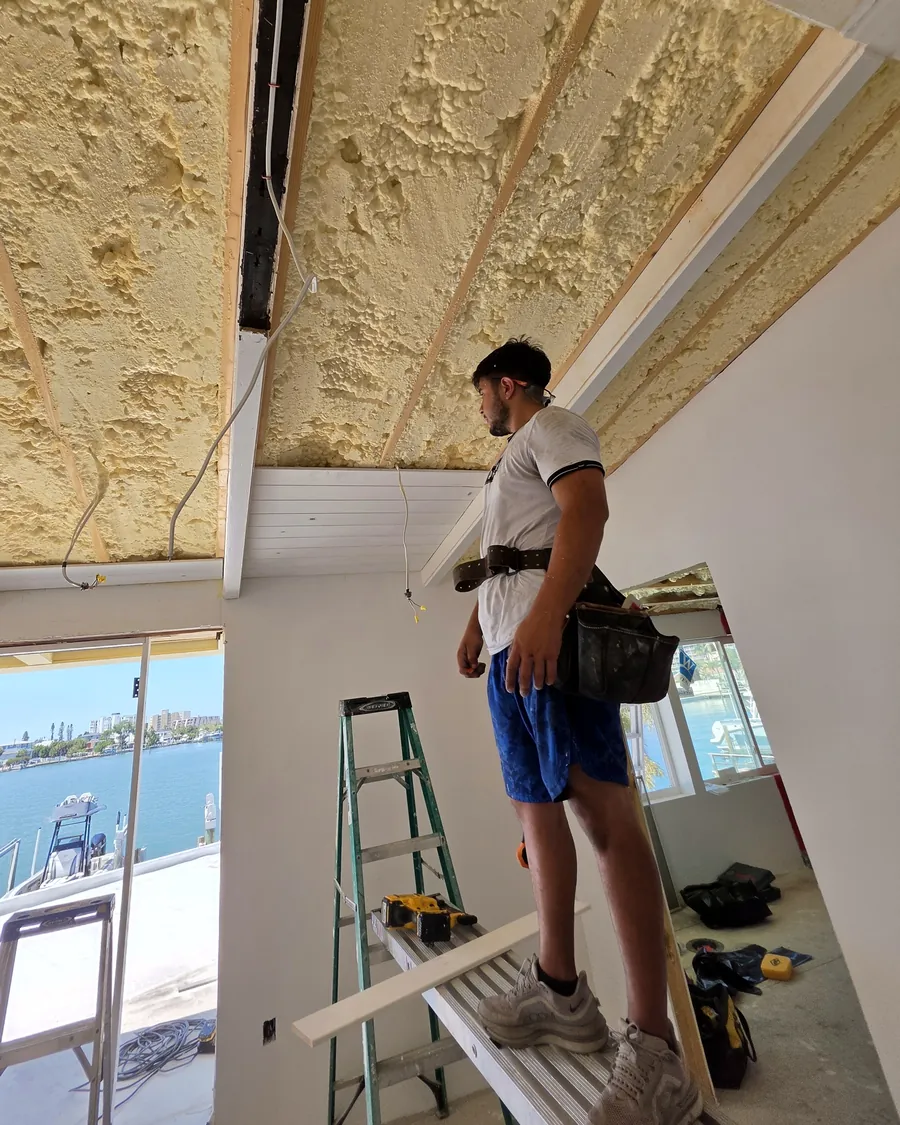 Weslei Fabri on site, working on a vaulted ceiling by the water